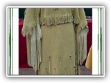 A beautiful deer leather dress, design and made by Ron Sass. Hand cut fringe, long, long arm fringe, glass and metal beads and cones. One of his best creations. Under-arms are gusseted for easier (and cooler) wearing.(L-1)